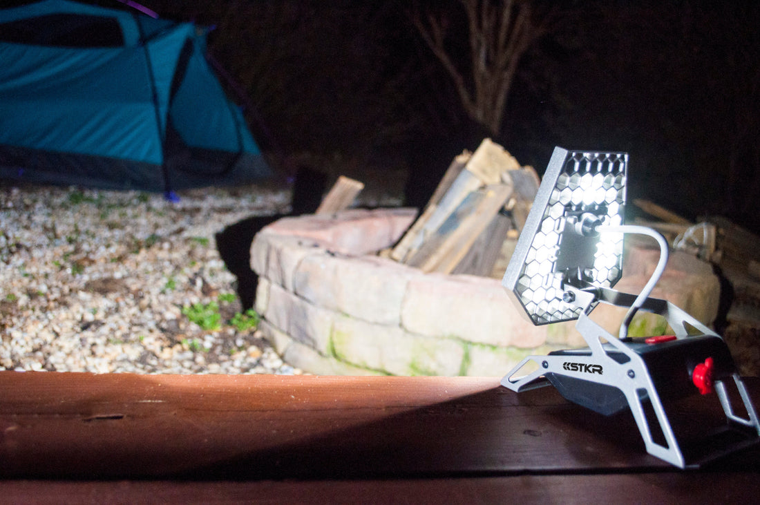Mobile task light lighting up a camp site.