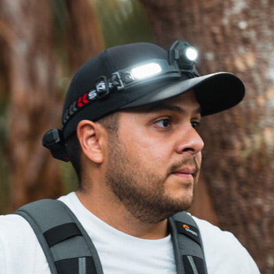 Male hiker wearing a hat with an STKR Headlamp on it.