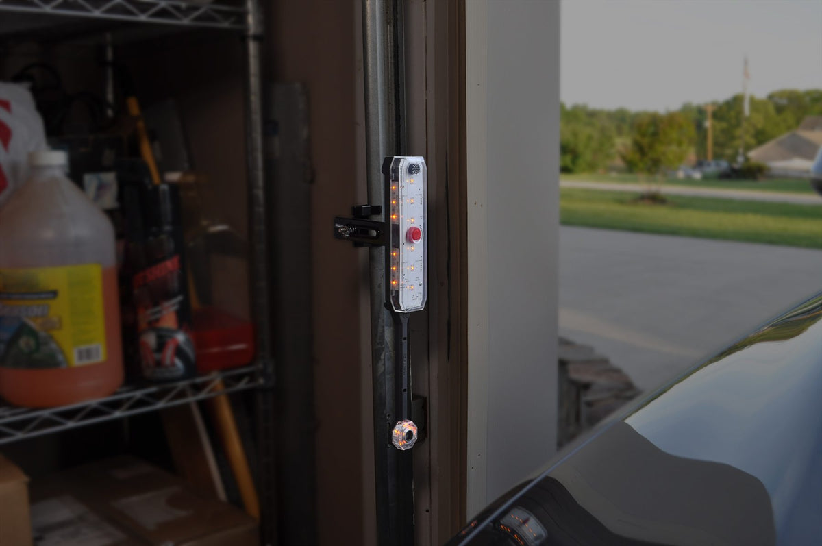 Adjustable side parking sensor mounted to a garage door track