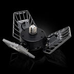 A 360-degree rotating LED floodlight with three wings, featuring a black central body, silver metal wings, and a threaded screw-in socket on a white background.