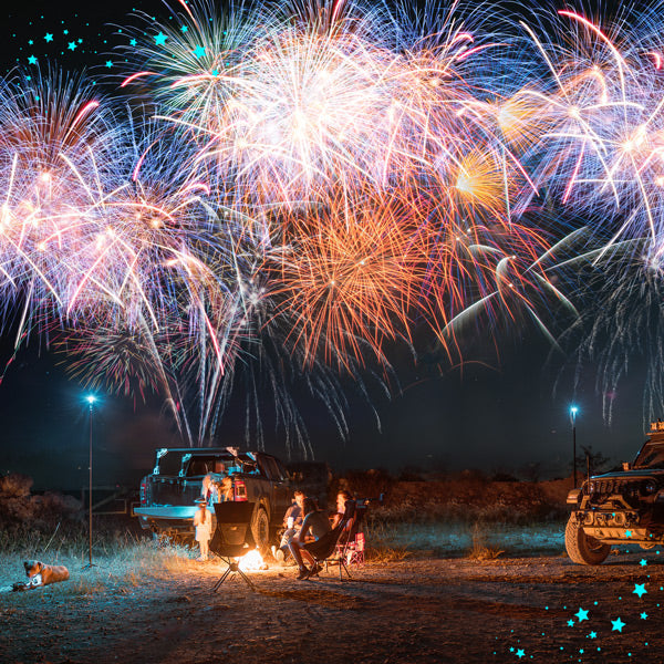 4th of July website banner featuring an overlanding night time theme lit up by overlanders and a sky full of fireworks