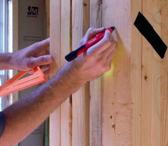 Marking a wall stud with the STKR Mechanical Carpenter Pencil